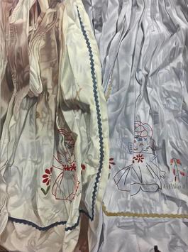 Embroidery of twins hiding in the folds