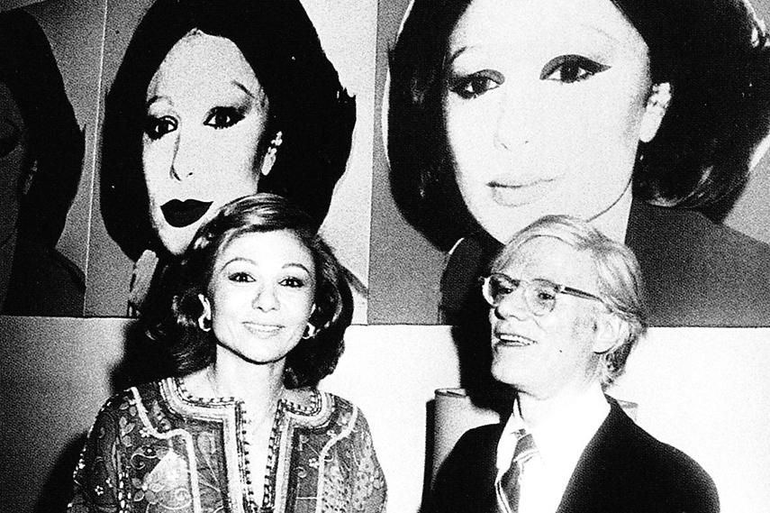 Farah Pahlavi with Andy Warhol in 1977 next to her portrait done by the artist. Photo via collectortribune.com