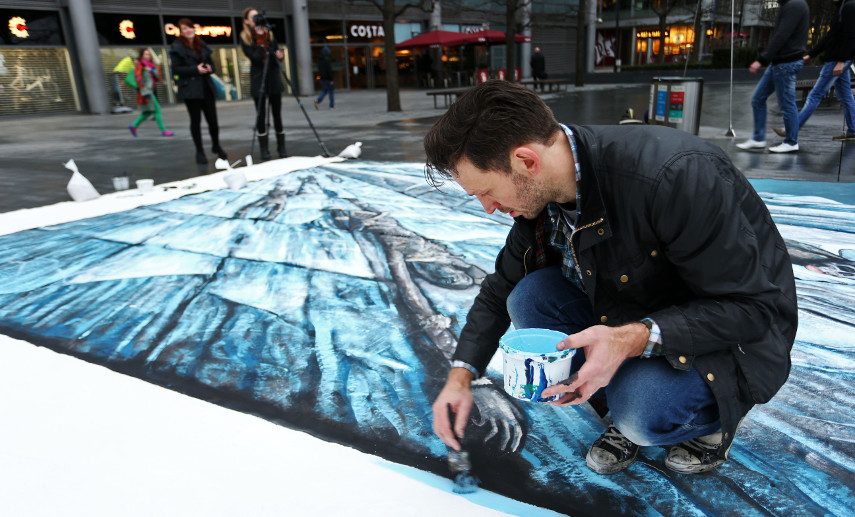 An image of the artist working on the HBO commission of a 3D street art of The Wall in London - Original gift was a commission of a featured portrait 