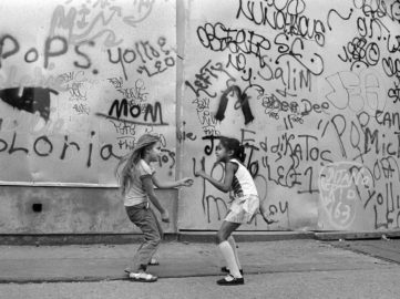 Martha Cooper - Girls Dancing to Disco Music from a Bar Against Graffiti Wall