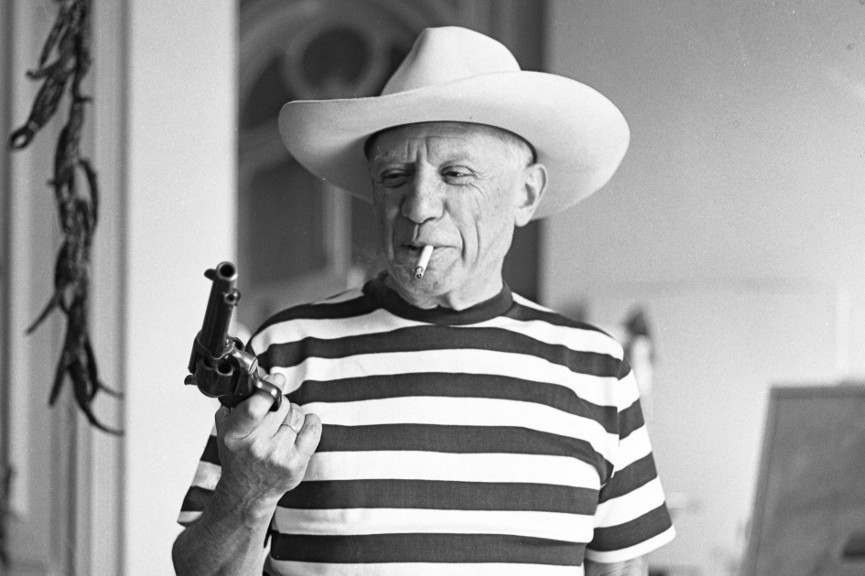 Pablo-Picasso-wearing-a-hat-and-holding-a-revolver-and-holster-provided-by-Gary-Cooper-Cannes-1958-Image-via-imgurcom.jpg